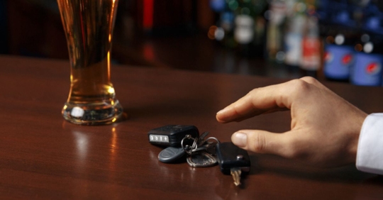 patron with beer and keys on bar
