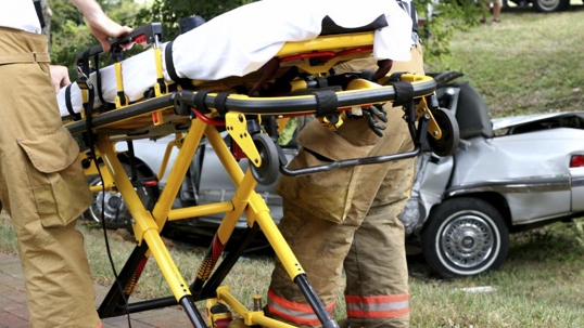 paramedics rolling a stretcher